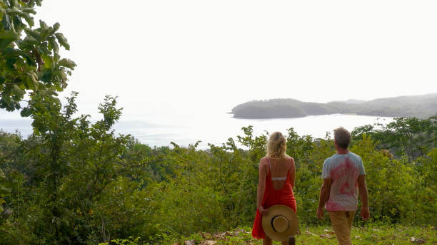 istock Mature couple walks through tropical rainforest in the morning 1297282940