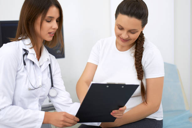 istock Woman in expectation visiting doctor at modern clinic 1297282949