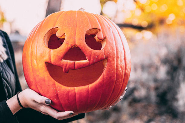 istock Cute Jack-O-Lantern Smiling Happy Face Carved Halloween Pumpkin 1297284766