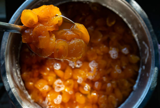 marmalade in a spoon while making fruit marmalade. stock photo