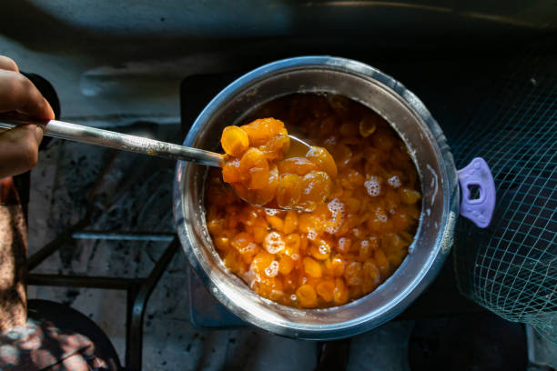 marmalade in a spoon while making fruit marmalade. stock photo