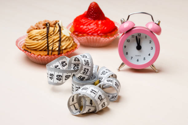 istock Sweet food measuring tape and clock on table 1297287201