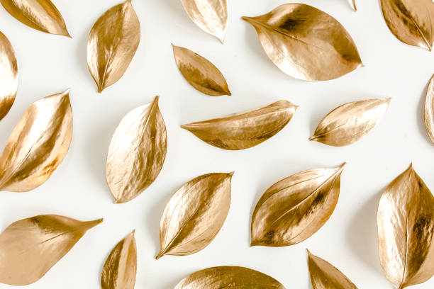 istock Pattern, texture with gold leaves isolated on white background. flat lay, top view 1297287801