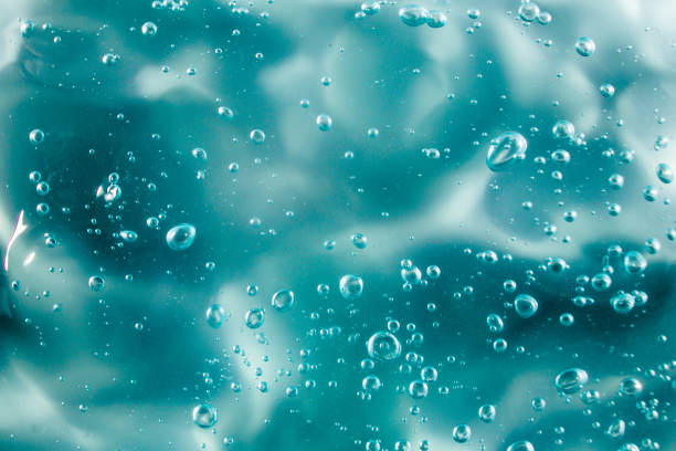 gel crema liquida, texture cosmetica blu verde con bollicine - gel per capelli foto e immagini stock