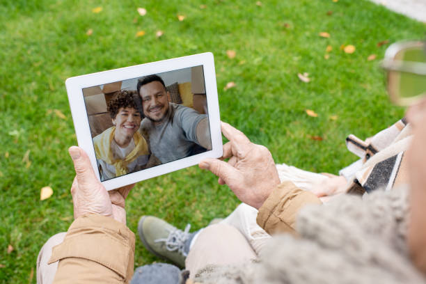 istock Young affectionate couple on tablet display talking to their senior parents 1297289241