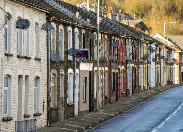 Traditional terraced housing in the South Wales valleys Rhondda, Wales - January 2018: Row of terraced houses on a road. This style of housing is common in the South Wales valleys welsh culture stock pictures, royalty-free photos & images