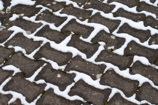 istock snow in the gaps between paving stones 1297289705