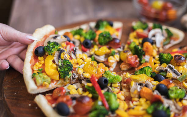 istock Vegetarian Pizza with Broccoli, Cherry Tomato, Pepper and Mushrooms 1297290972