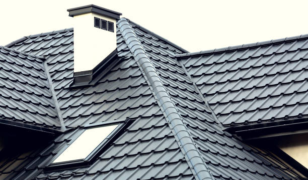 Roof of a new house with slants, a skylight, a plastered chimney and ventilation grilles. Roof covering with steel tiles. Roof of a new house with slants, a skylight, a plastered chimney and ventilation grilles. Roof covering with steel tiles. rooftop stock pictures, royalty-free photos & images