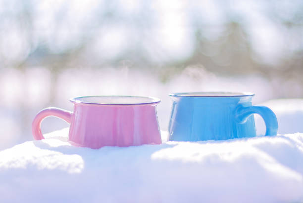 istock two cups stand in the snow 1297291274