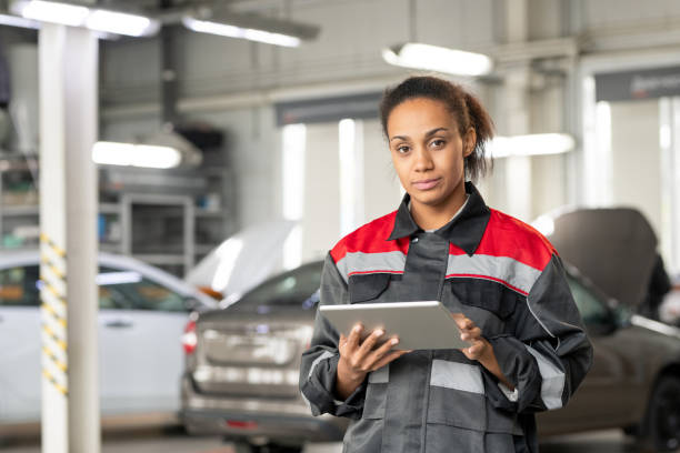 istock Young car service worker looking at you while scrolling through online questions 1297291570