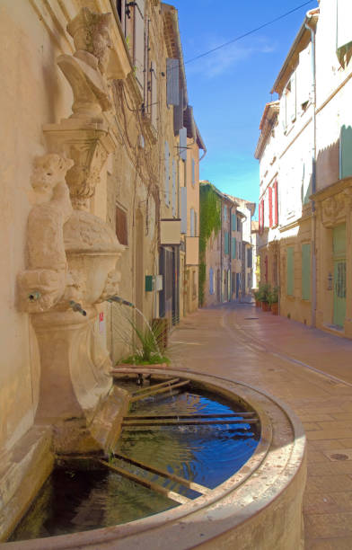 Nostradamus-Fountain in Saint-Rémy-de-Provence Saint-Rémy-de-Provence, France, August 2018: Street in the old town with Nostradamus Fountain nostradamus stock pictures, royalty-free photos & images