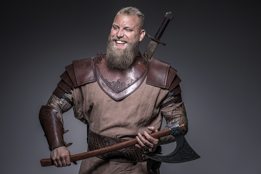 Weapon wielding viking warrior in studio shot