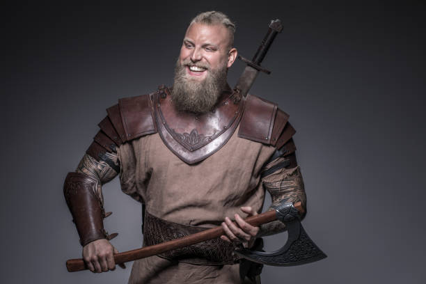 Weapon wielding viking warrior in studio shot Weapon wielding viking warrior in studio shot body armor stock pictures, royalty-free photos & images