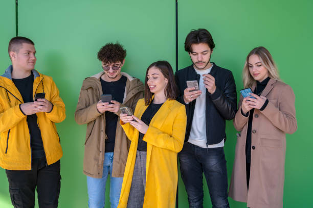 istock Young friends chatting in social networks, having break at college 1297292518