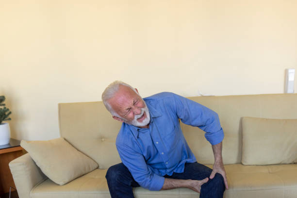 istock Lonely Older Man with Chronic Knee Problems is Desperate while Struggling with Insufferable Pain. 1297293198