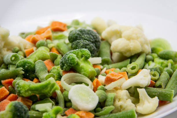istock Frozen vegetables: cauliflower, green peas, leeks, broccoli, carrots, green beans on a white plate. 1297293245