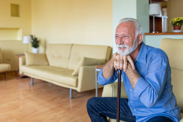 istock Lonely Senior Man is Sitting on Sofa at Home and Looking Confident. 1297293267