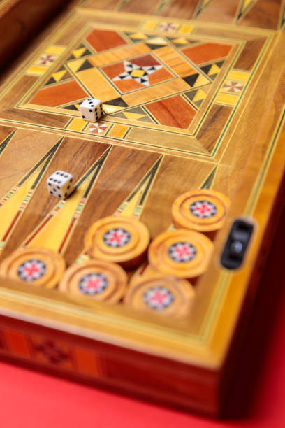 istock An entertaining backgammon game. Checkers, cubes, handmade board 1297293560