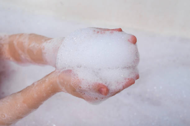 istock Children's hands hold the foam. Taking a bath, hygiene procedures. 1297293704