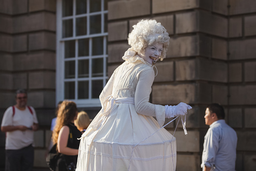 A costumed pantomime street performer along the historic Royal Mile in Edinburgh, Scotland at the annual Fringe Festival.