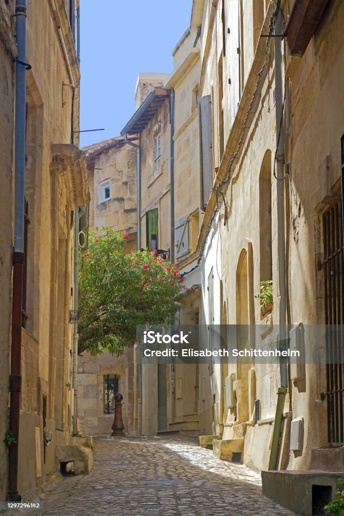 Street in Arles, France Arles, August 2018: Idyllic street in the old town of Arles in the South of France Ancient Stock Photo