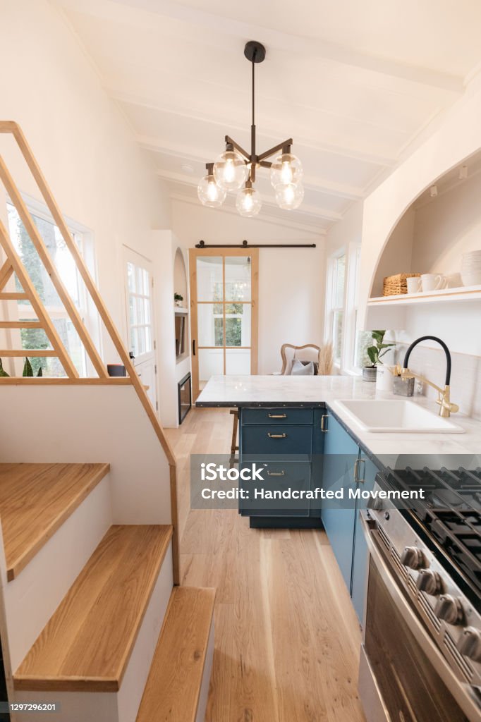 Vertical Photo of Tiny House Interior Decor Interior Decor shot of Tiny House on a trailer, featuring a small space kitchen, bedroom, and bathroom. Tiny House Stock Photo