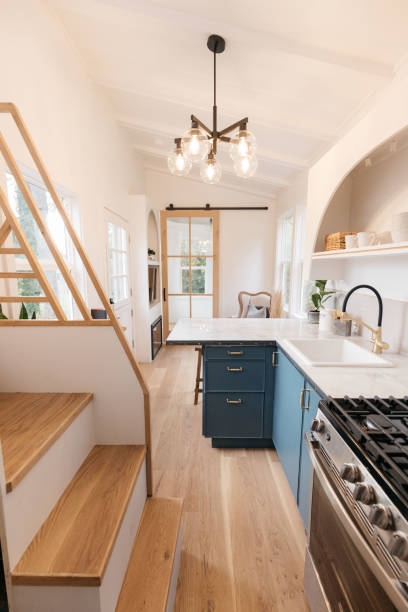 Vertical Photo of Tiny House Interior Decor Interior Decor shot of Tiny House on a trailer, featuring a small space kitchen, bedroom, and bathroom. tiny house stock pictures, royalty-free photos & images