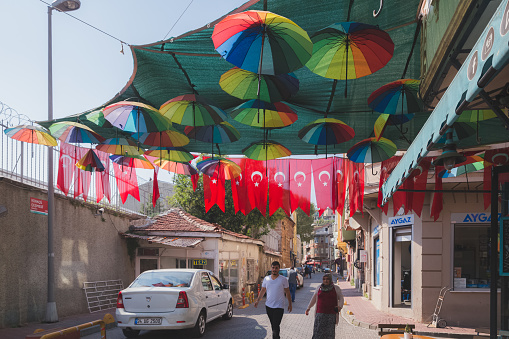 Locals and tourists shop and stroll along the colourful streets in the local multicultural Istanbul neighbourhood of Balat, known for hip cafes and galleries.