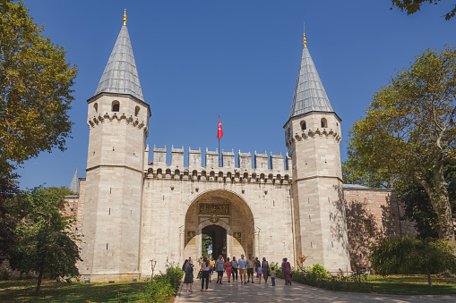 The Imperial Gate and entrance to the historical landmark Topkapi Palace on a clear sunny day in Istanbul.