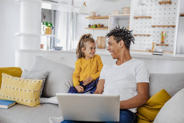 istock Young father and his daughter are using laptop at home 1297297870