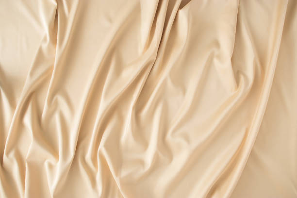 istock Beige light brown silk sheet. Minimal concept. Flat lay 1297299095
