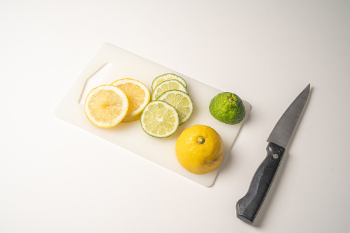 Sliced lemon and lime on cutting board