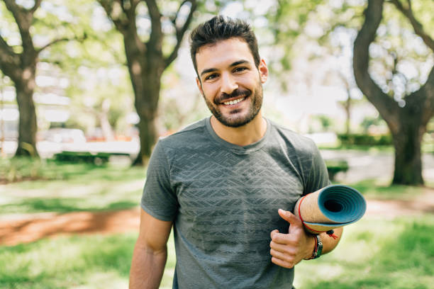 istock Man doing yoga in urban park 1297301381