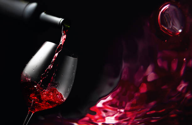 pouring red wine in a glass goblet. - action alcohol alcoholism bar imagens e fotografias de stock