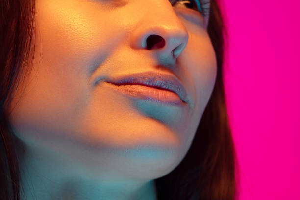 istock Caucasian beautiful woman's portrait isolated on pink studio background in multicolored neon light 1297303843