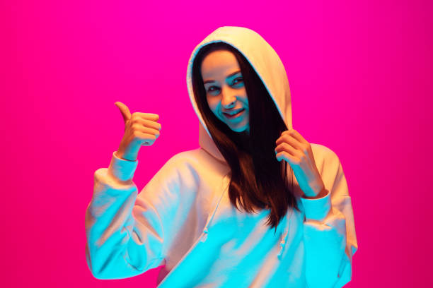 istock Caucasian beautiful woman's portrait isolated on pink studio background in multicolored neon light 1297303849