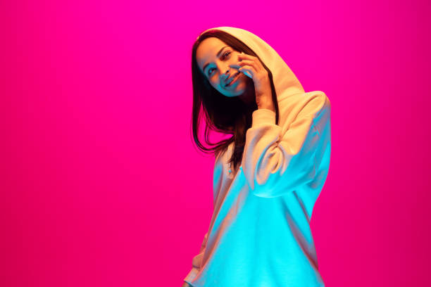 istock Caucasian beautiful woman's portrait isolated on pink studio background in multicolored neon light 1297303853