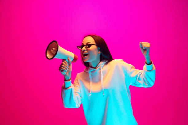 istock Caucasian beautiful woman's portrait isolated on pink studio background in multicolored neon light 1297303858