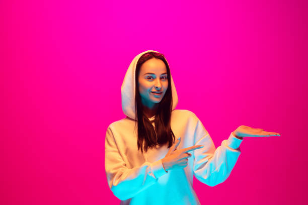 istock Caucasian beautiful woman's portrait isolated on pink studio background in multicolored neon light 1297303861