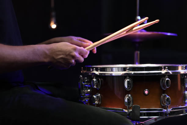 istock Drummer playing snare drum with sticks close up. 1297304106