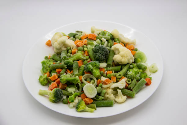 istock Frozen vegetables: cauliflower, green peas, leeks, broccoli, carrots, green beans on a white plate. 1297304290