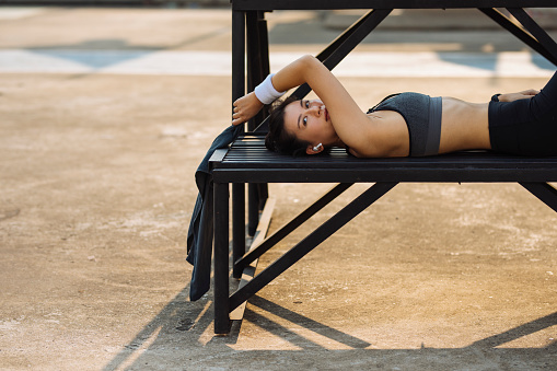 Asian sportswoman having a rest from her workout