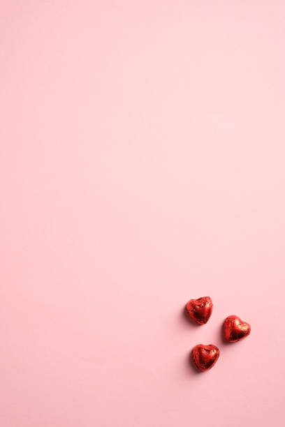 istock Minimalist Valentines day background with heart shaped sweets. Top view with copy space. Vertical banner, brochure, poster mockup 1297314009
