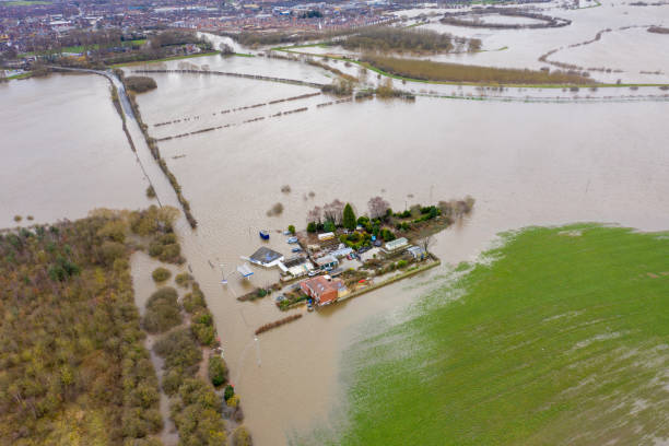 Aerial drone photo of the town of Allerton Bywater near Castleford in Leeds West Yorkshire showing the flooded fields and farm house from the River Aire during a large flood after a storm. stock photo