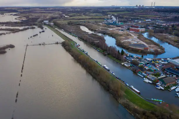 Aerial drone photo of the town of Allerton Bywater near Castleford in Leeds West Yorkshire showing the flooded fields from the River Aire on a rainy winters day during a large flood after a storm.