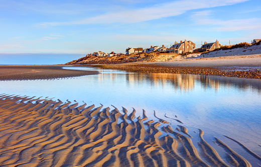 Row of beach houses during Golden Hour at sunrise along the coast of Maine,  New England USA.