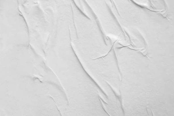 istock Blank white crumpled and creased paper poster texture background 1297323640