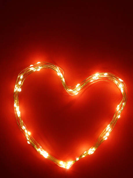 istock burning heart from christmas lights on a red background 1297323993