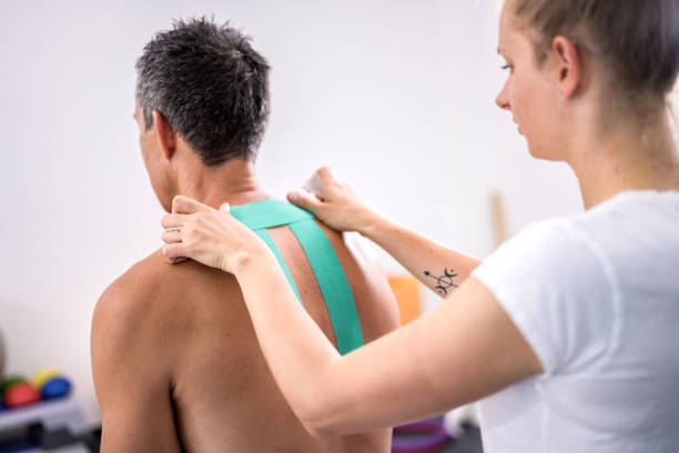 istock Woman applying green Kinesio tape 1297324032
